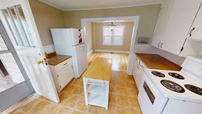 Fredericton apartment for rent - A kitchen with white appliances and wooden floors.