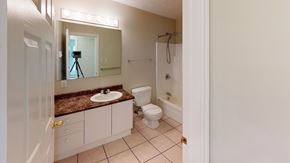 Fredericton apartment for rent - A bathroom with a sink, toilet, and a mirror.
