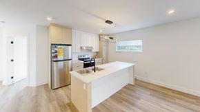 Fredericton apartment for rent - A kitchen with a white countertop and wooden flooring.