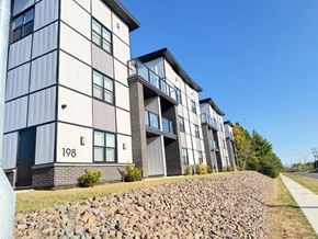 Fredericton apartment for rent - Apartment building 198 with a stone wall in front.