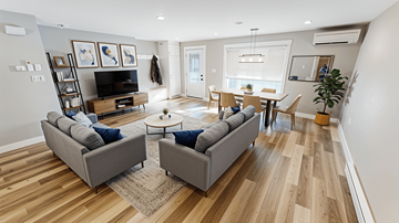 Fredericton apartment for rent - A living room with a grey couch and a wooden floor.