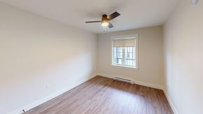 Fredericton apartment for rent - A room with a ceiling fan and a window with blinds.
