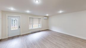 Fredericton apartment for rent - A room with a white door and a window with a white frame.