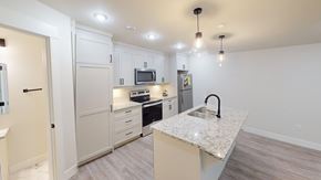 Fredericton apartment for rent - A kitchen with a granite countertop and a microwave above it.