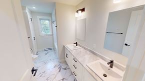 Fredericton apartment for rent - A bathroom with a marble floor and white walls.