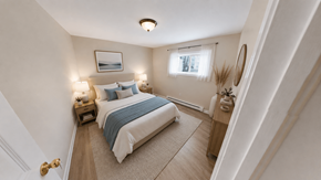 Fredericton apartment for rent - A bedroom with a bed, nightstands, and a window.