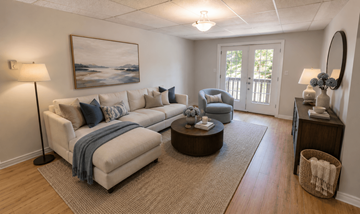 Fredericton apartment for rent - A living room with a couch, chair, and a painting on the wall.