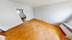 Fredericton apartment for rent - A room with wooden flooring and a window.