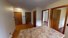 Fredericton apartment for rent - A room with a granite countertop and wooden doors.