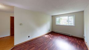 Fredericton apartment for rent - A room with wooden floors and a window.