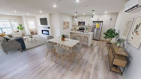 Fredericton apartment for rent - A modern open plan living and kitchen area with a dining table and chairs.