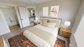 Fredericton apartment for rent - A bedroom with a large bed and a rug on the floor.