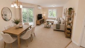 Fredericton apartment for rent - A living room with a wooden dining table and white chairs.