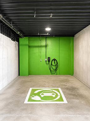 Fredericton apartment for rent - A parking space with a green sign on the floor.