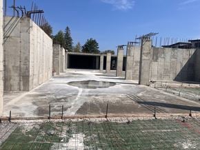 Fredericton apartment for rent - A construction site with a large open space in the middle and a concrete wall on the left side.
