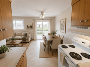 Fredericton apartment for rent - A kitchen with a stove, table and chairs.