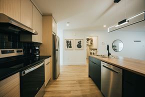 Fredericton apartment for rent - A modern kitchen with wooden cabinets and stainless steel appliances.