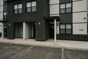 Fredericton apartment for rent - A black and white building with the number 198 on it.