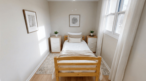 Fredericton apartment for rent - A bedroom with a bed, nightstands, and two framed pictures on the wall.