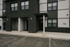 Fredericton apartment for rent - A black and white building with the number 198 on it.