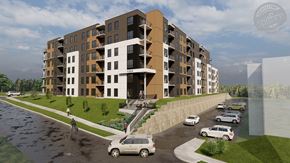Fredericton apartment for rent - A modern apartment building with a parking lot in front.