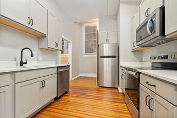 Huntington apartment for rent - A kitchen with white cabinets and stainless steel appliances.