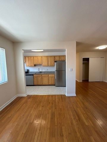 Alexandria apartment for rent - A kitchen with wooden cabinets and a refrigerator.