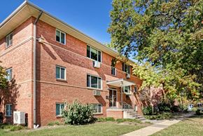 Alexandria apartment for rent - A red brick building with a tree in front.