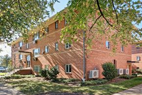 Alexandria apartment for rent - A red brick building with trees in front.