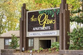 Falls Church apartment for rent - A sign for The Glen Apartments stands in front of a building.