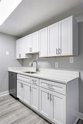Falls Church apartment for rent - A kitchen with white cabinets and a white countertop.