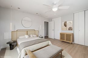 Falls Church apartment for rent - A bedroom with a large bed and a wooden headboard.