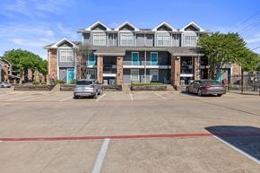 Dallas apartment for rent - A parking lot in front of a multi-story apartment building.
