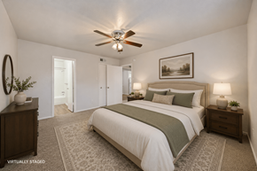 Austin apartment for rent - A bedroom with a bed, nightstands, and a ceiling fan.