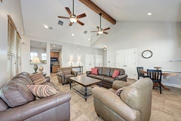 Pflugerville townhouse for rent - A living room with brown leather couches and a ceiling fan.
