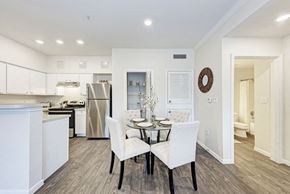 Round Rock apartment for rent - A modern kitchen with a dining table set for two.