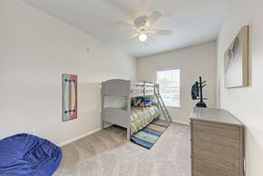 Round Rock apartment for rent - A bedroom with a bunk bed and a blue bean bag chair.