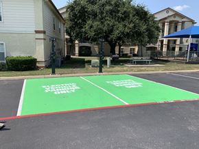 Round Rock apartment for rent - A parking lot with two green parking spaces for electors only.