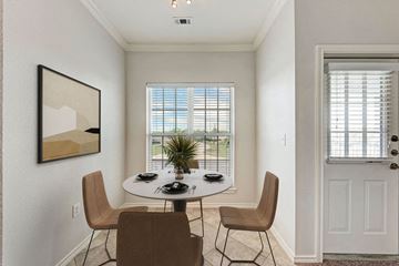 Pflugerville apartment for rent - A dining room with a white table and chairs.
