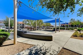 Las Vegas apartment for rent - A playground with a blue canopy and a concrete structure.