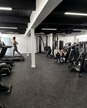 Las Vegas apartment for rent - A woman is running on a treadmill in a gym with various exercise equipment.