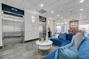 Las Vegas apartment for rent - A living room with a blue couch and a white coffee table.
