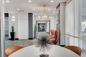 Las Vegas apartment for rent - A modern conference room with a white table and orange chairs.