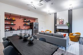 Reno apartment for rent - A modern dining room with a wooden table and grey couch.