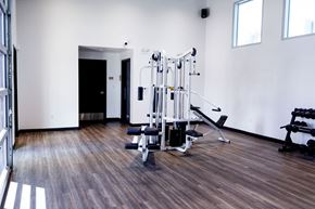 Las Vegas apartment for rent - A gym with a variety of equipment including a leg press machine.