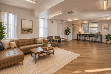 Las Vegas apartment for rent - A living room with a brown leather sofa and a wooden coffee table.