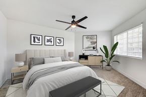 Las Vegas apartment for rent - A bedroom with a bed, nightstands, and a ceiling fan.