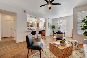 Las Vegas apartment for rent - A living room with a black leather chair and a wooden coffee table.