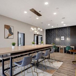 Las Vegas apartment for rent - A modern dining room with a long table and grey chairs.