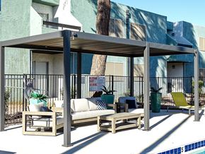 Las Vegas apartment for rent - A poolside lounge area with a canopy and seating.